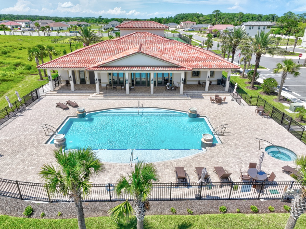Aerial view of the Marina Del Palma clubhouse and resort-style pool with tennis courts